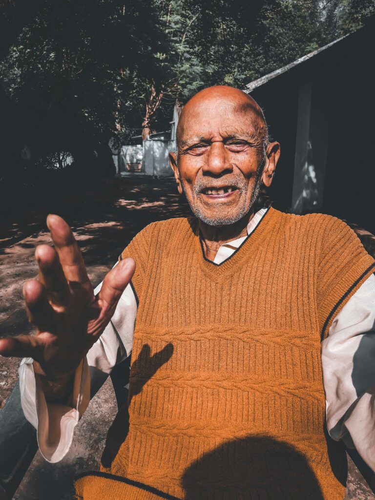 A happy senior man basking in the sun outdoors, captured in Ramgarh, India.